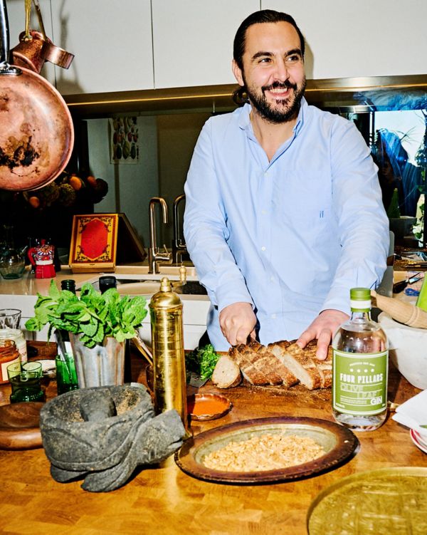 Melbourne chef Tom Sarafian cutting bread in his kitchen 