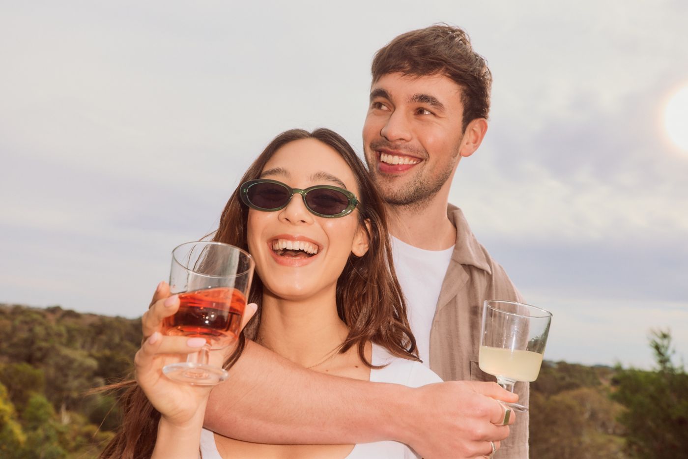 A couple enjoying a glass of wine together outdoors