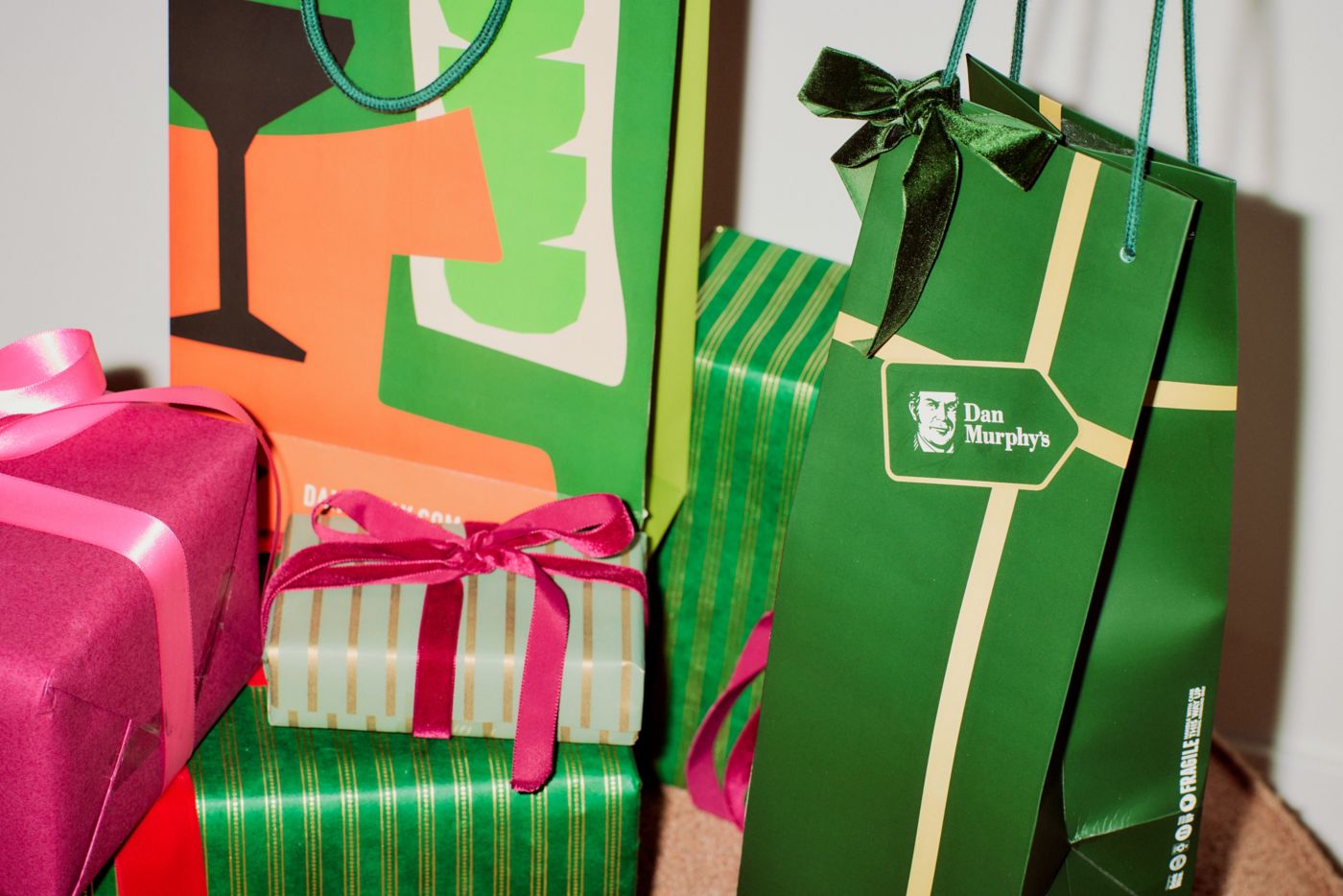 A Dan Murphy's gift bag next to other wrapped gifts