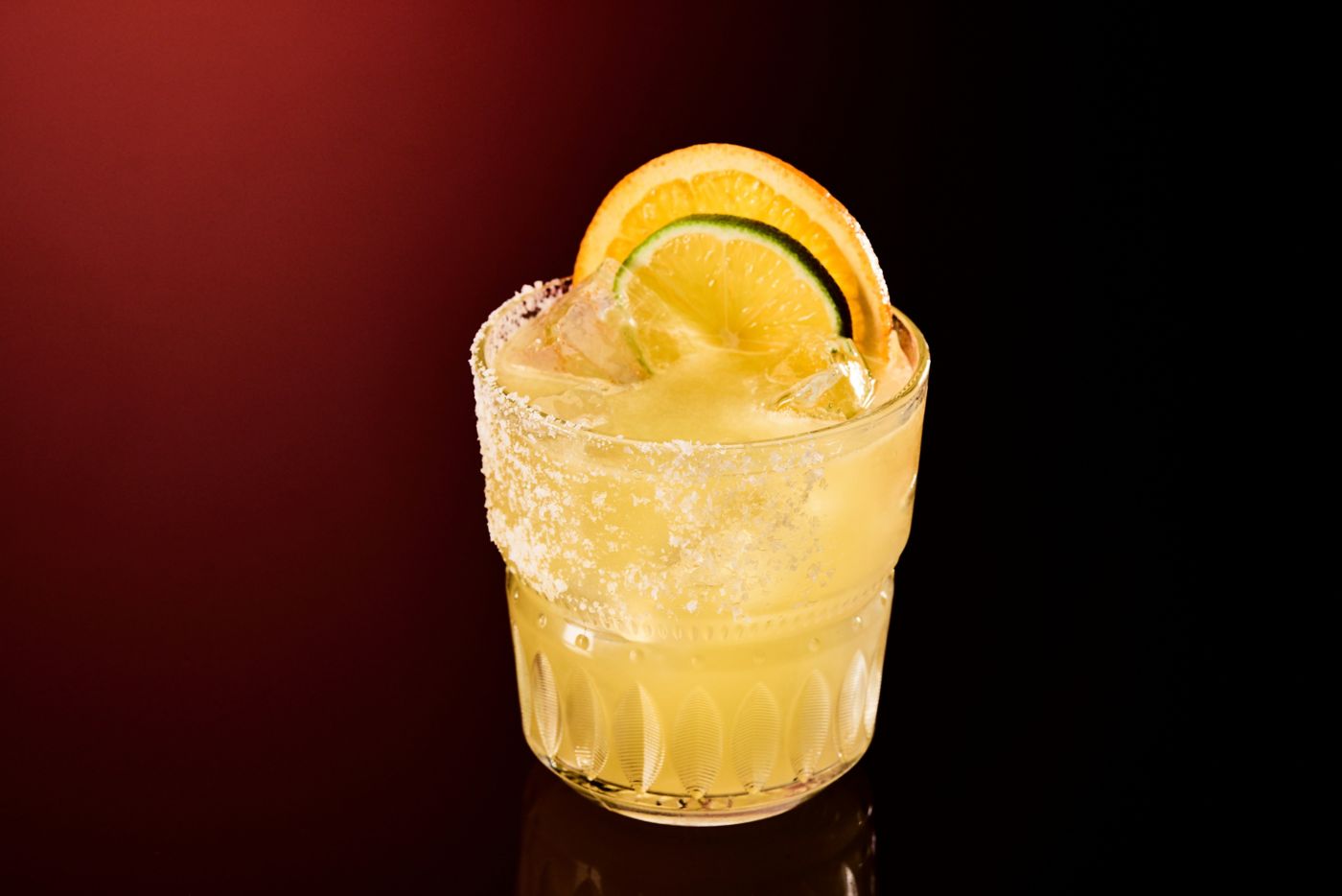 The Mezcalita cocktail is garnished with lime and orange wedges