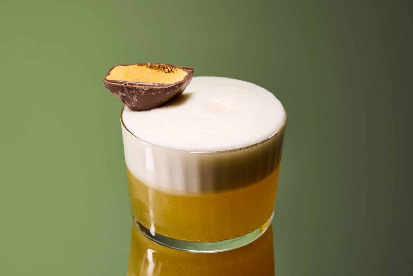 The Brown Butter & Sage Sour cocktail with a wedget of honeycomb as garnish