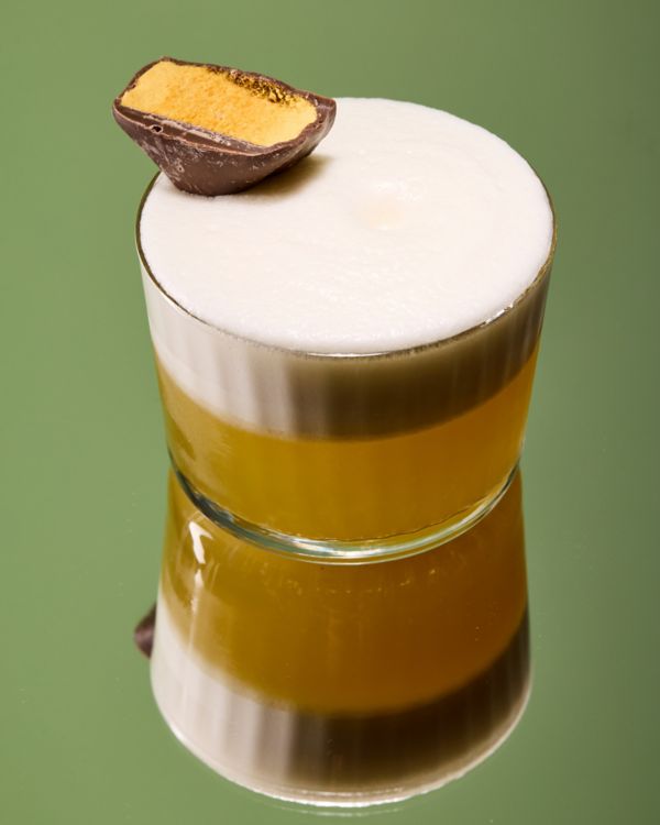 The Brown Butter & Sage Sour cocktail on a green table