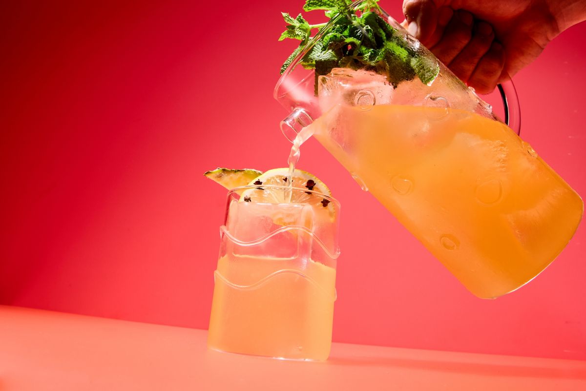 Pouring the Pisco Punch cocktail into a glass