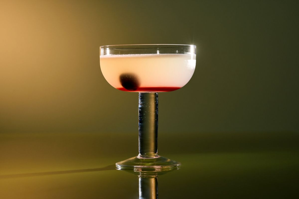 The Aviation cocktail is garnished with a cherry in the drink 