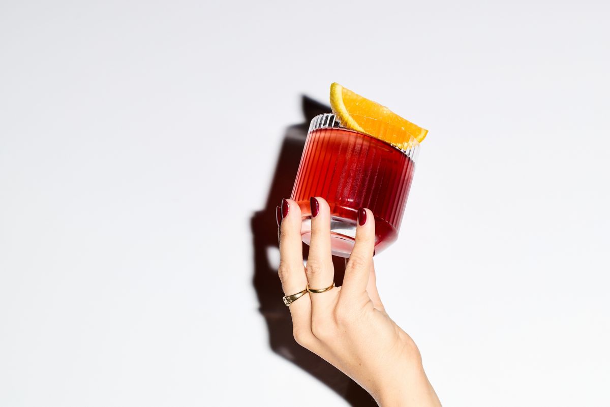 Holding the popular Negroni cocktail 