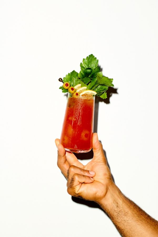 Holding the spicy Bloody Mary cocktail, a brunch staple  