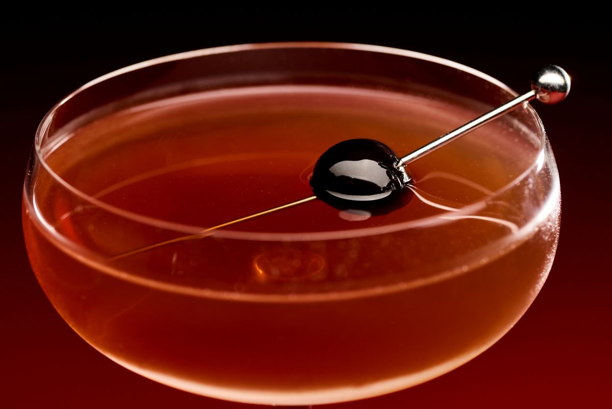 Looking into the top of a Manhattan cocktail with a skewered cherry 