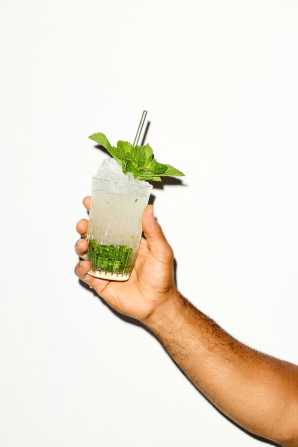 Holding the ever-popular Mojito cocktail 