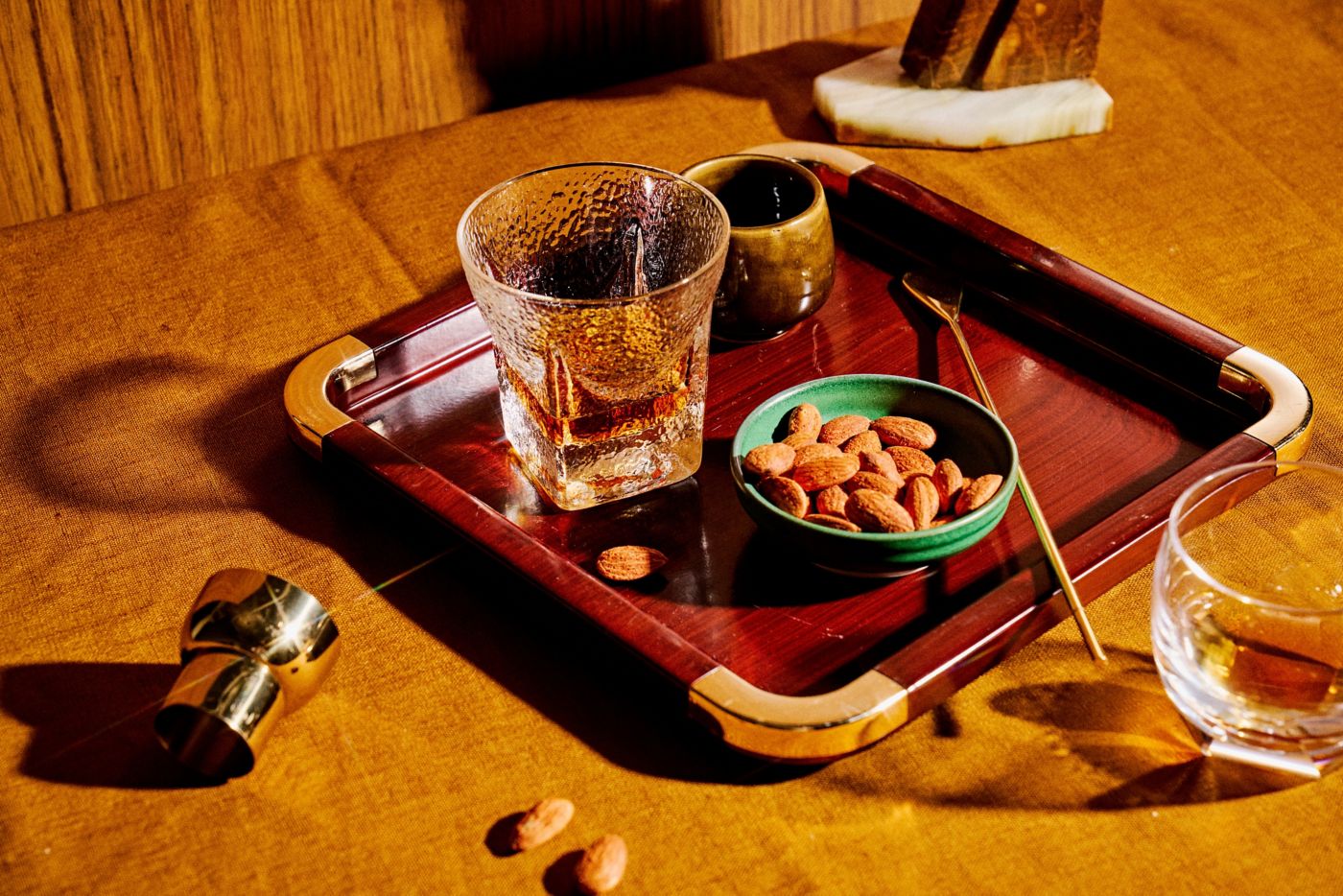 Glasses of rum on a table with almonds 