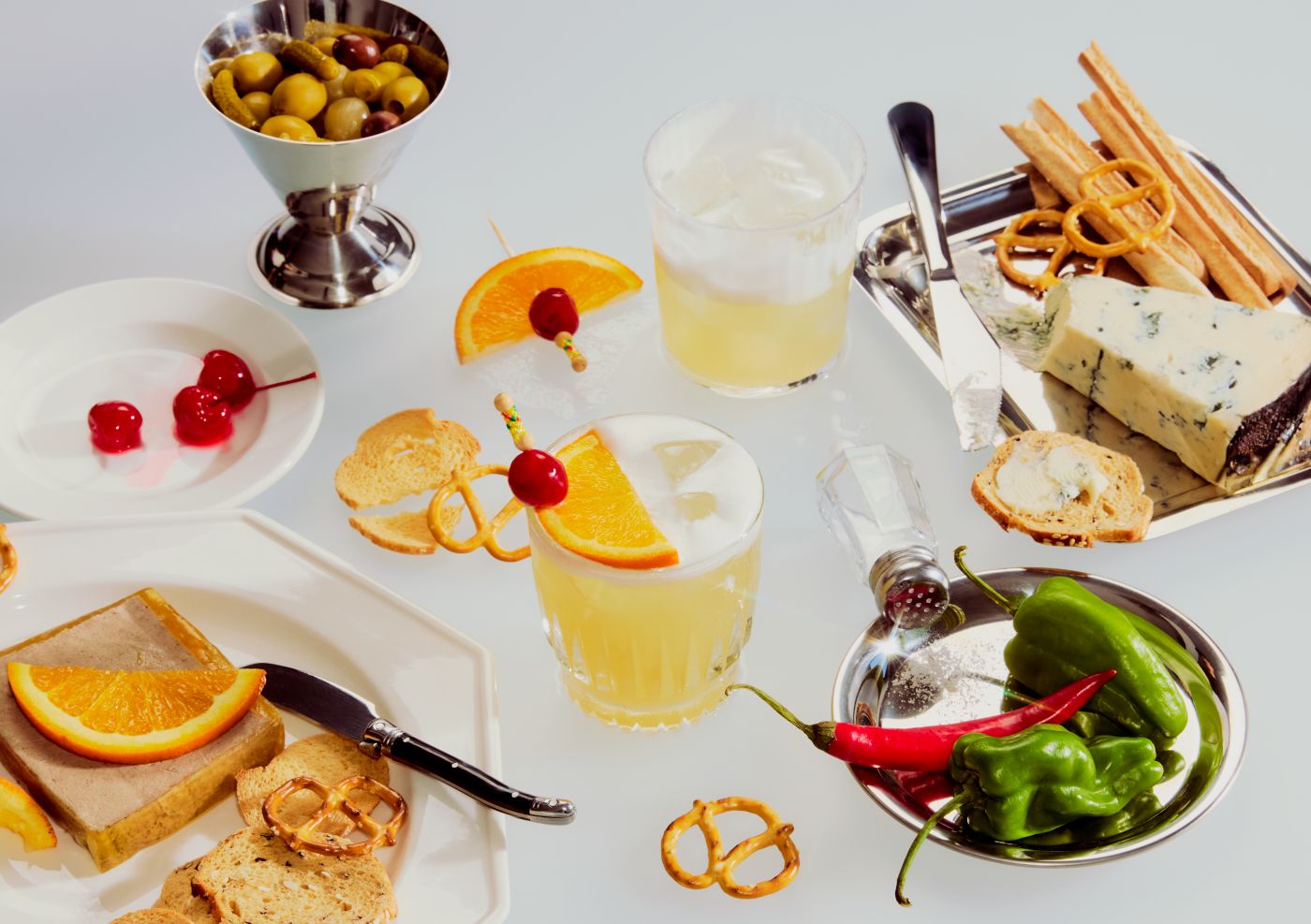 Cocktails on a table with various snacks