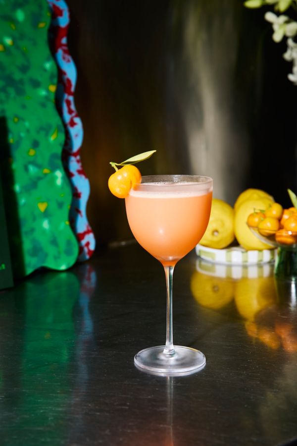The Cumquat Sour with a cumquat as garnish on the glass