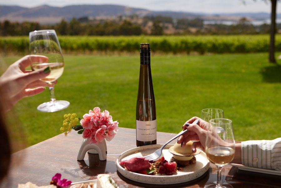 Picnic setting with a cheese board and cans of Liberty Coast Raspberry