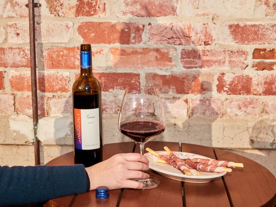 A bottle of the Grosset Gaia Cabernet Blend with snacks 