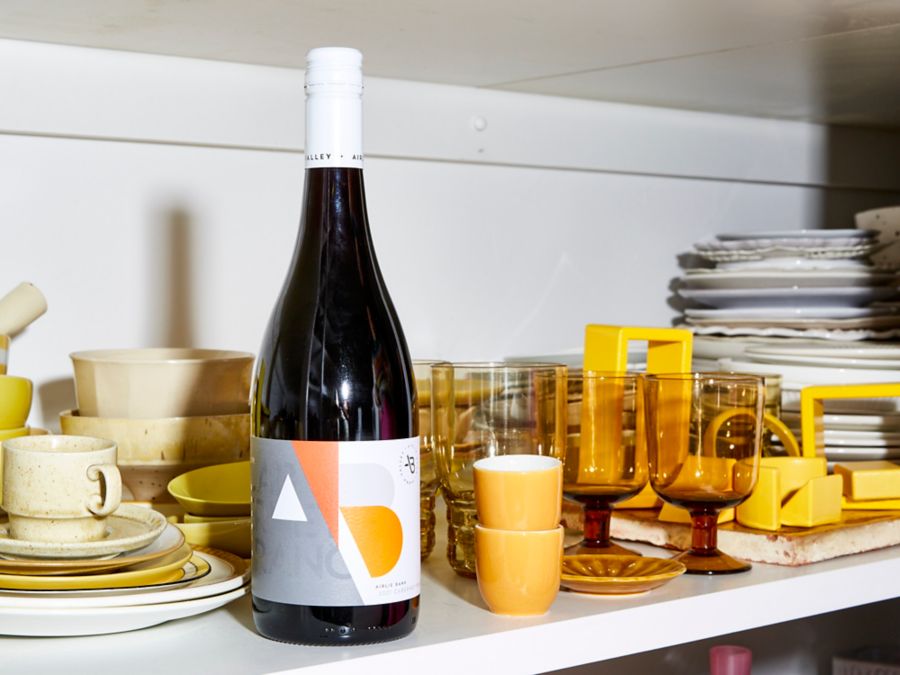 The Airlie Bank Cabernet Franc on a shelf with crockery and glasses