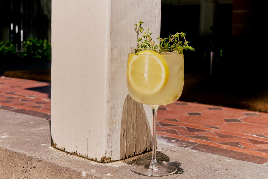 A cocktail garnished with fresh thyme
