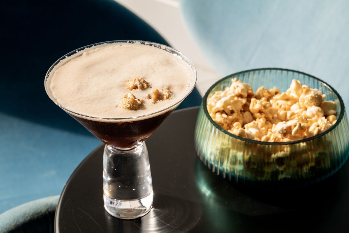 The Zero*% Salted Caramel Espresso Martini with a bowl of sweet popcorn