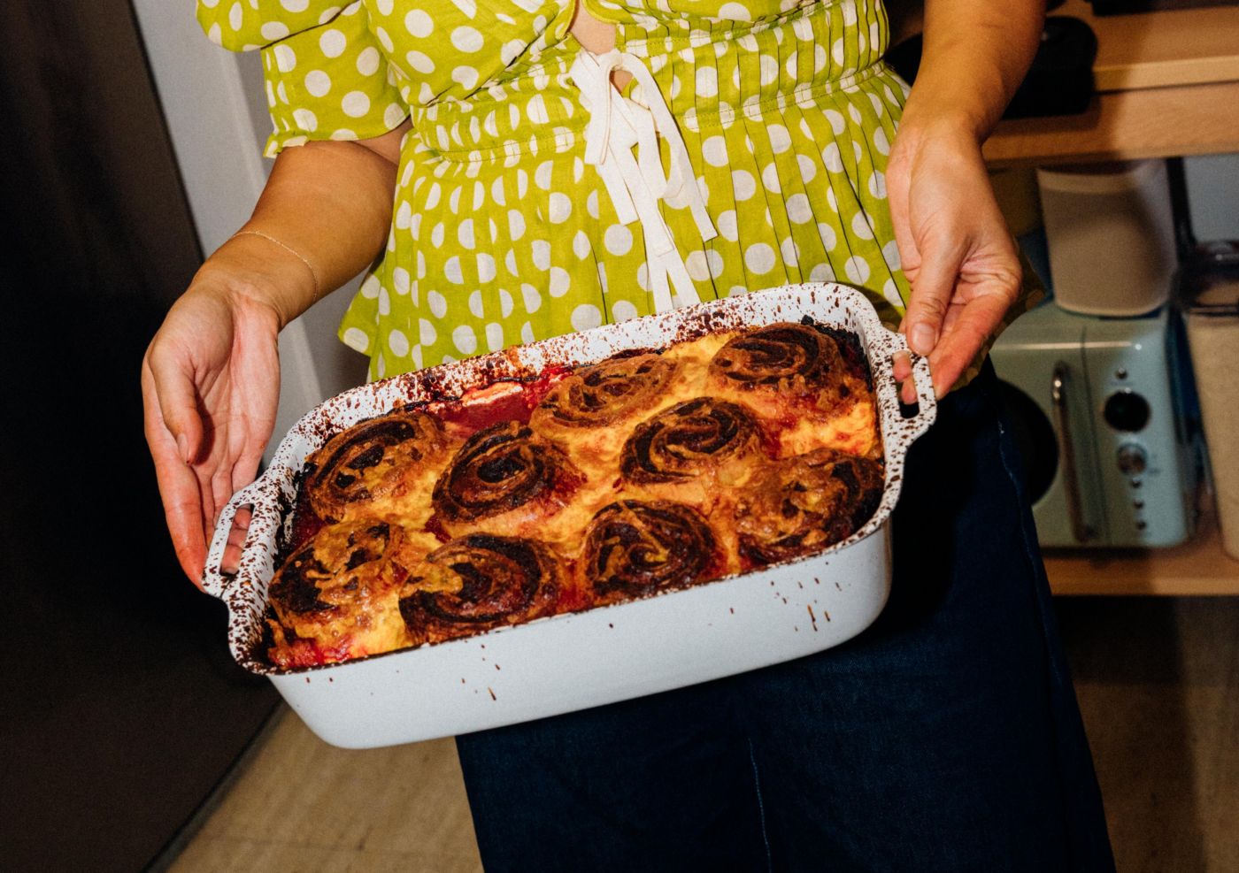 Jessica Nguyen holding a tray of lamb ragu lasagne rotolo