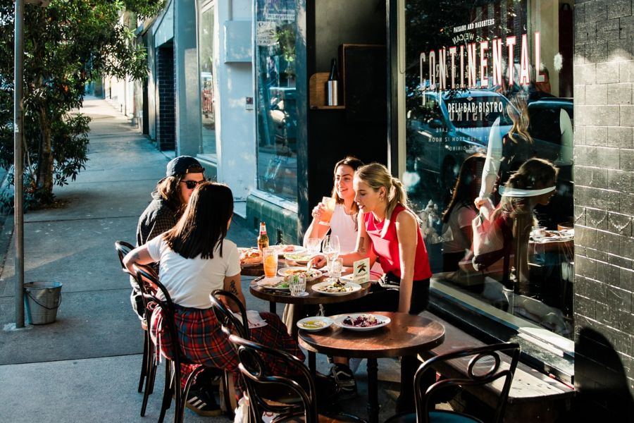 Patrons at tables outside Continental Deli in Newtown 