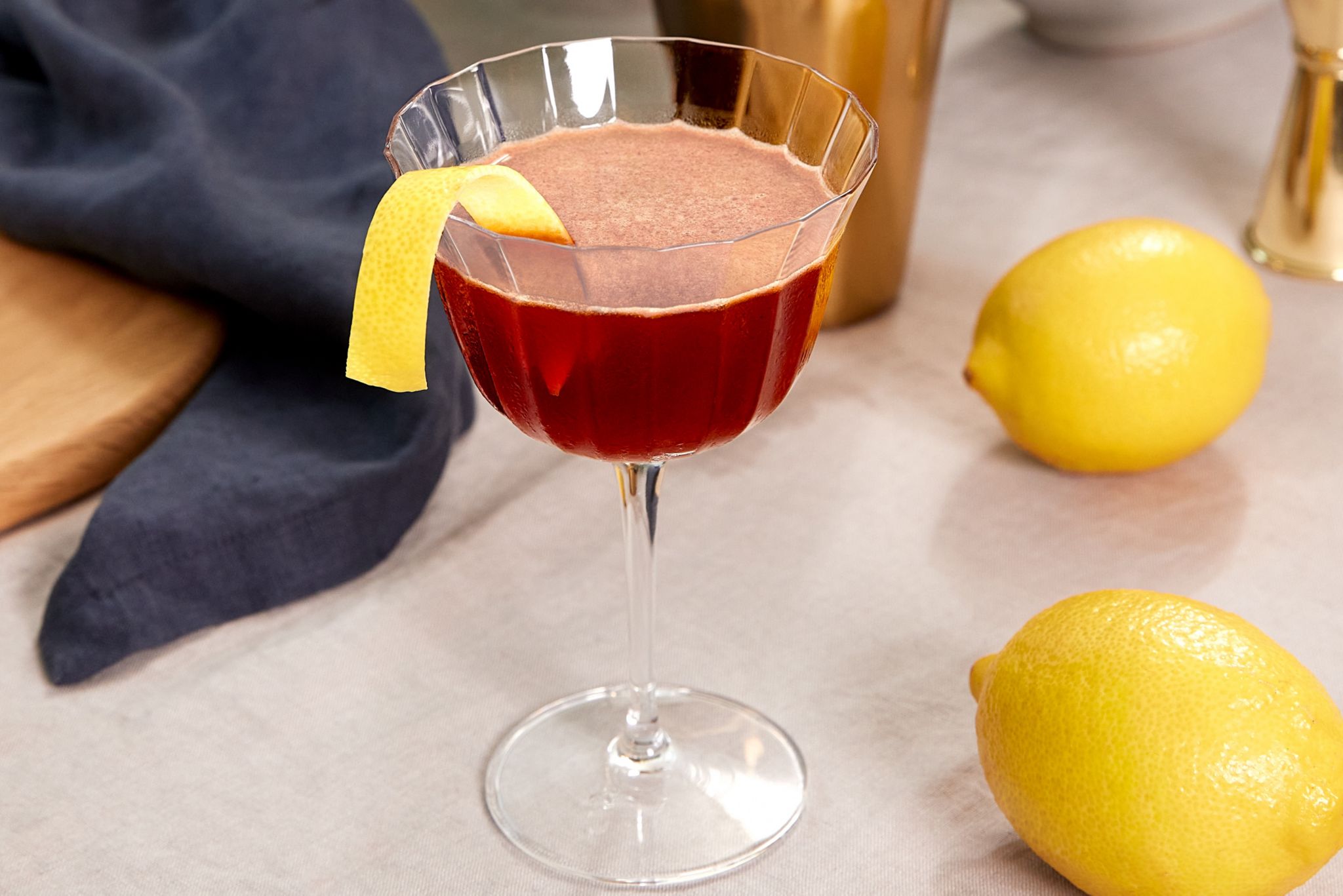 The Paper Plane cocktail, garnished with a lemon peel 