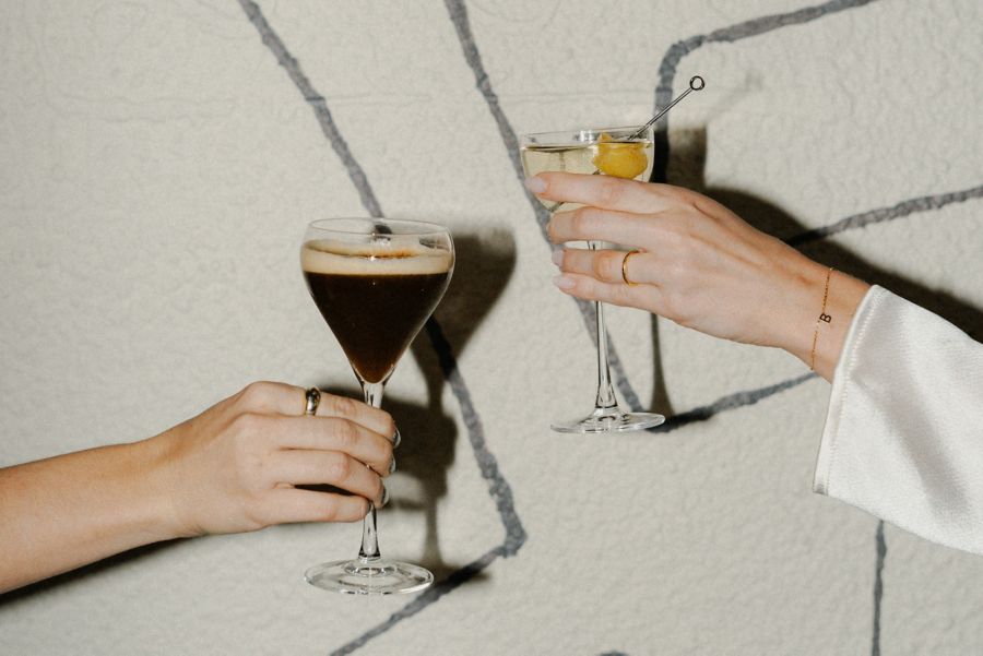 Holding cocktails against the mural inside The Standard in Perth