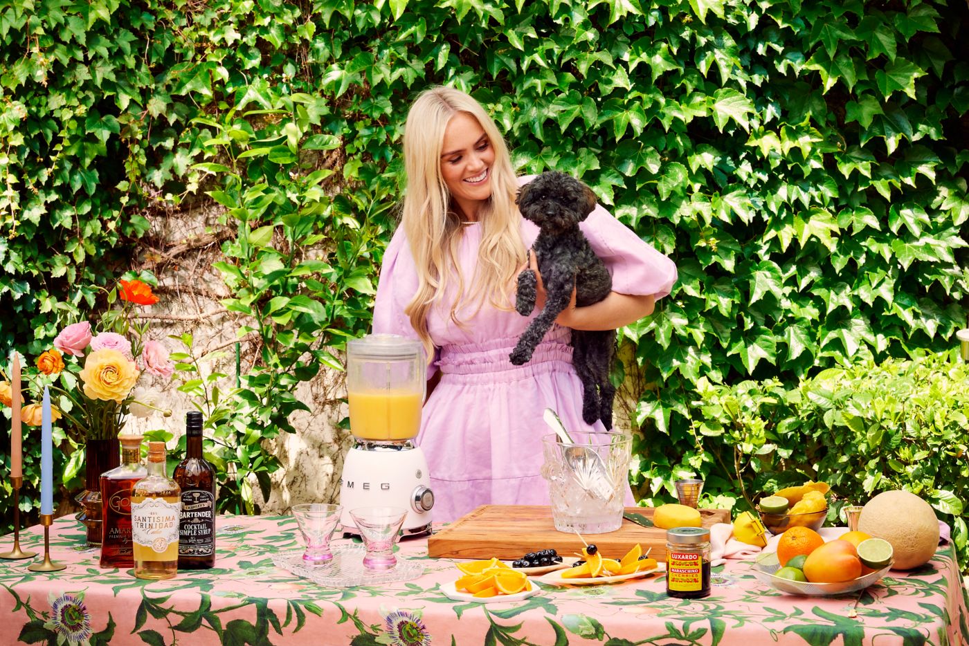Ava Chandler-Matthews with her dog, making a Mango and Amaretto Daiquiri