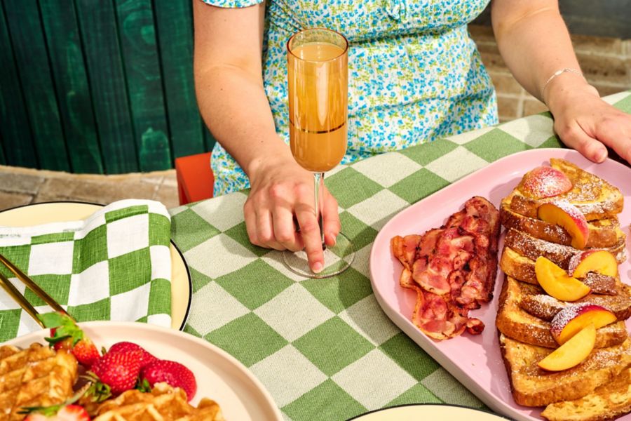 A Bellini with a spread of peaches and waffles