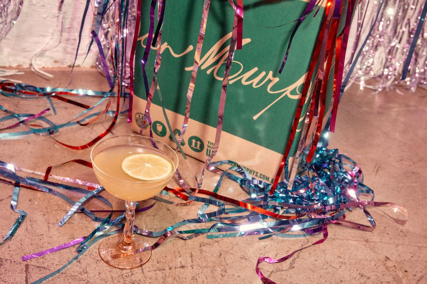 A festive scene with party streamers and a Dan Murphy's bag