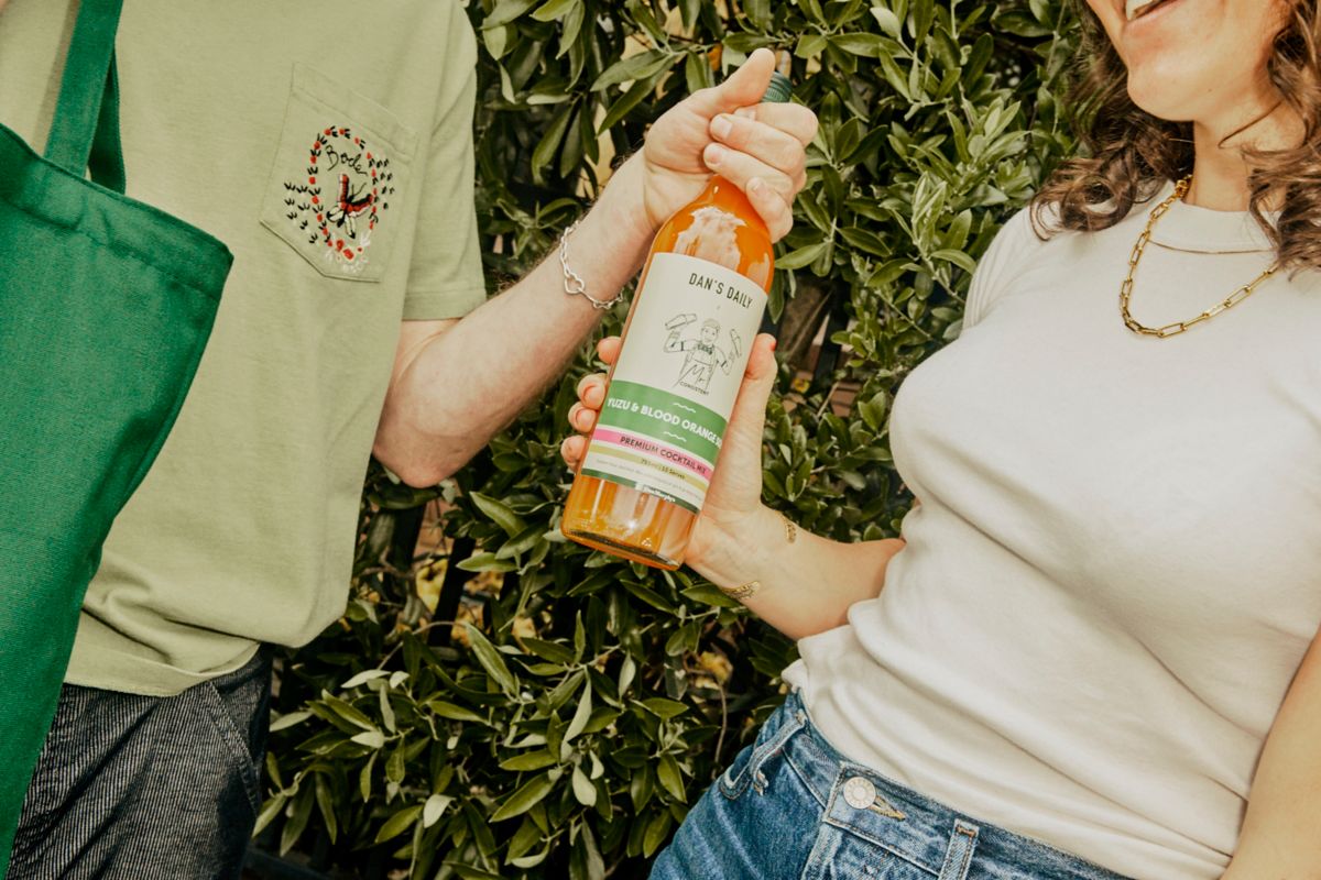 Holding a bottle of Mr Consistent Yuzu & Blood Orange Sour