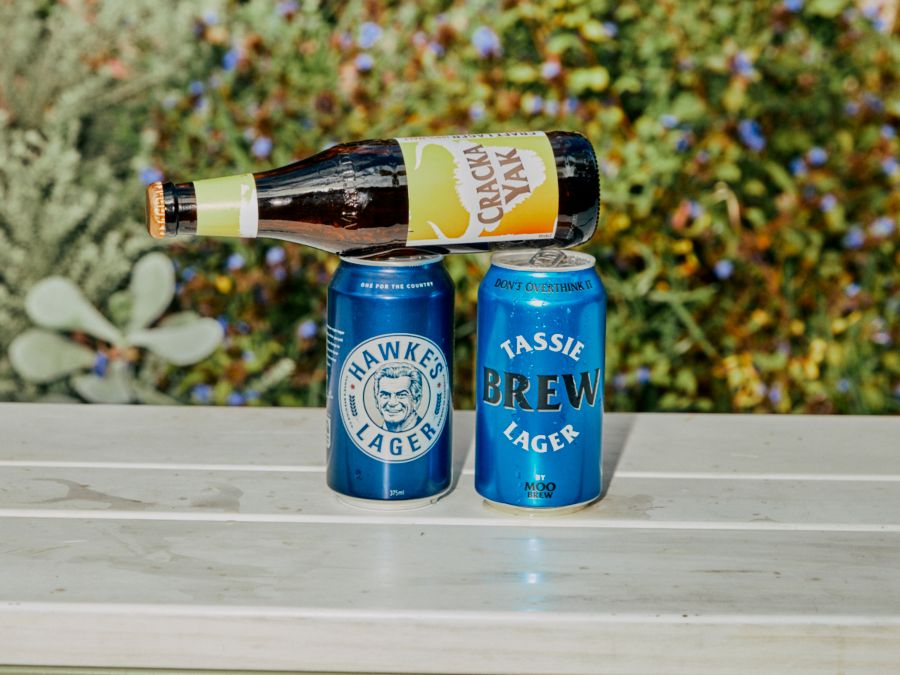 Several lagers together on a bench outside