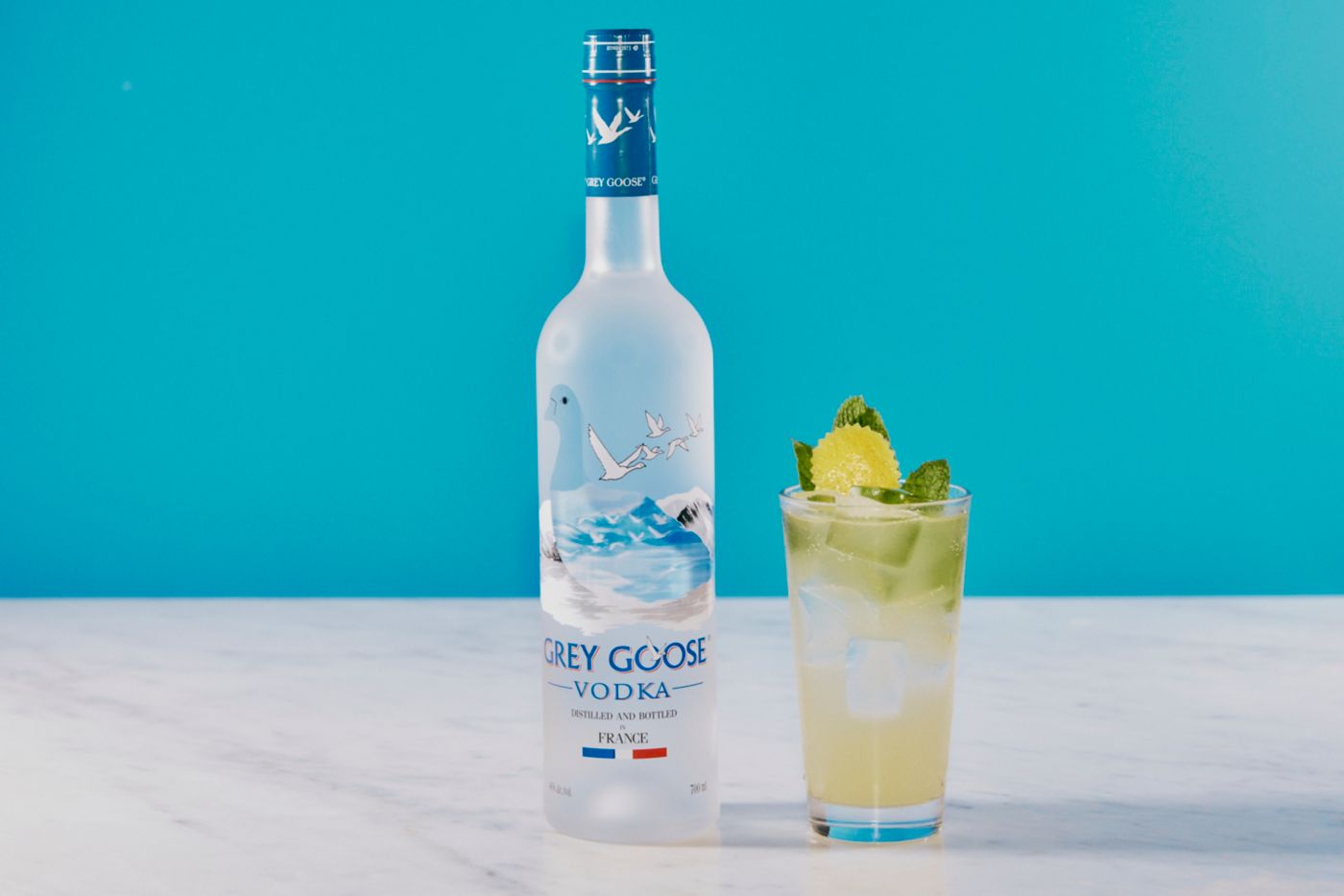 The Grey Goose Lemon Ace cocktail next to a bottle of Grey Goose