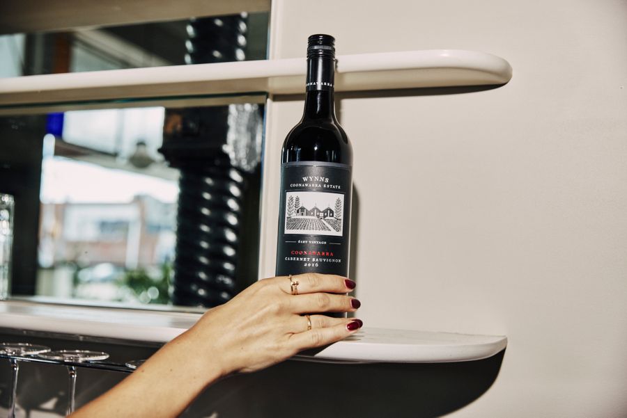 Holding a bottle of the Wynns Black Label Cabernet Sauvignon 2016