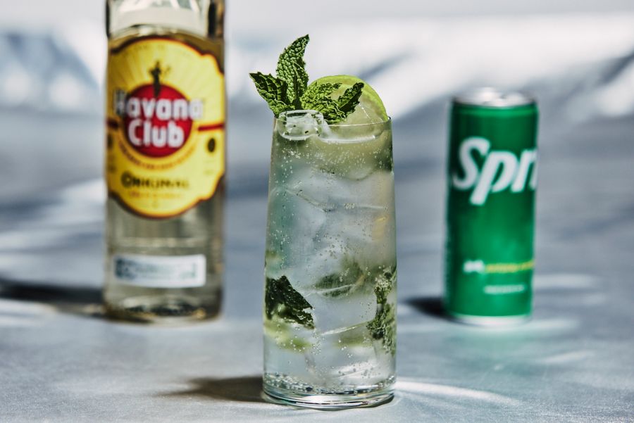 A light rum cocktail with a bottle of light rum and can of Sprite 