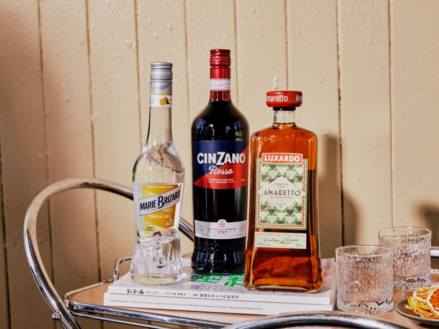 LIqueurs on a bar cart with magazines and glasses