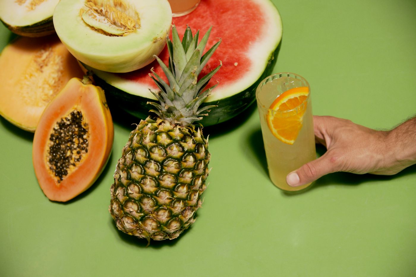 A selection of peak-summer fruit and a highball cocktail 