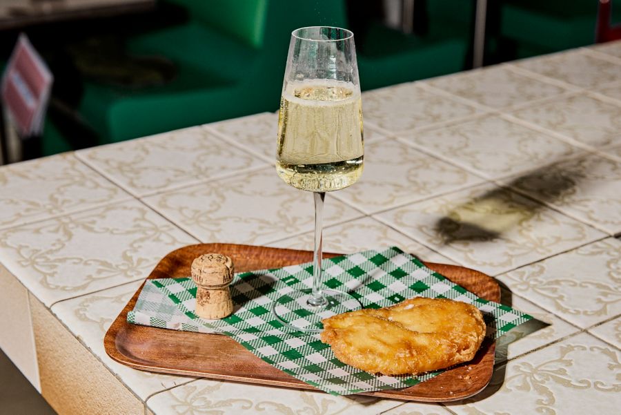 Potato cakes on a tray with a glass of sparkling