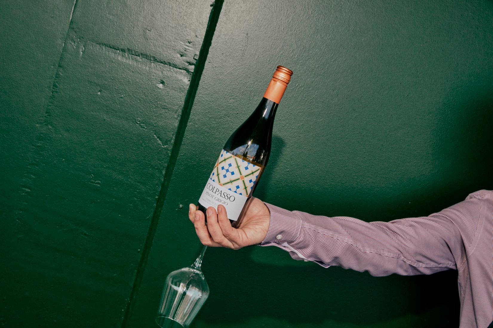 Holding a bottle of the popular Colpasso Pinot Grigio