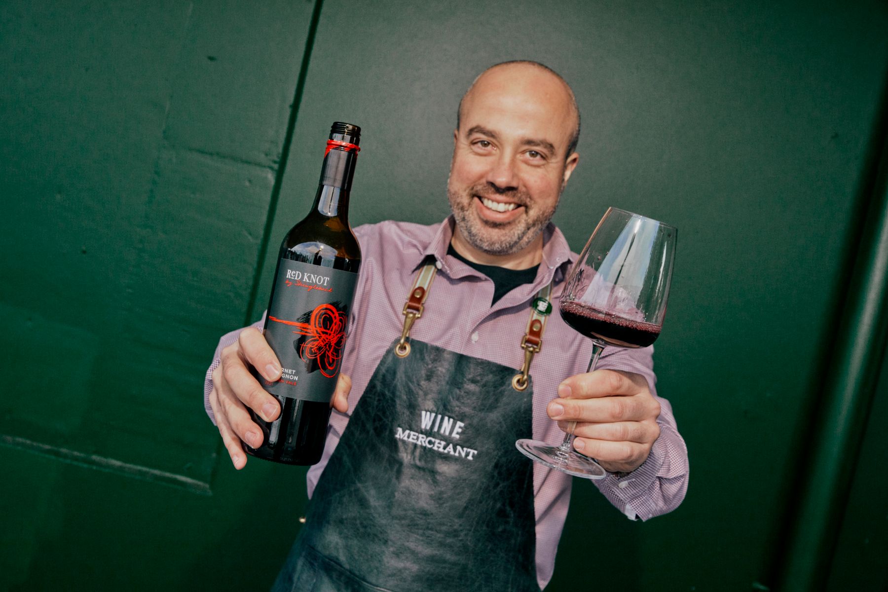Wine merchant Mario Laus with a bottle of Shingleback Red Knot Cabernet Sauvignon.