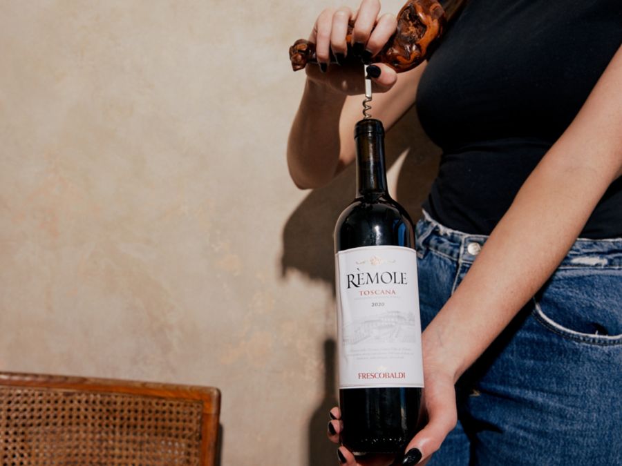 Opening a bottle of Frescobaldi Rosso di Toscano Remole with a corkscrew