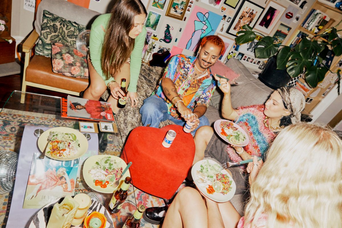 Sean and friends eating and drinking in the living room