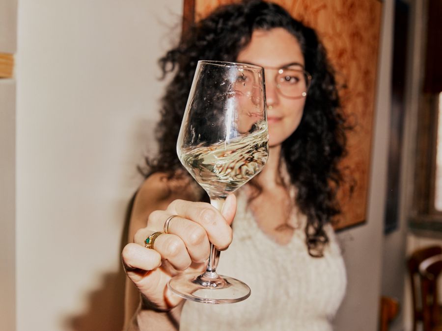 Woman swirling glass of white wine