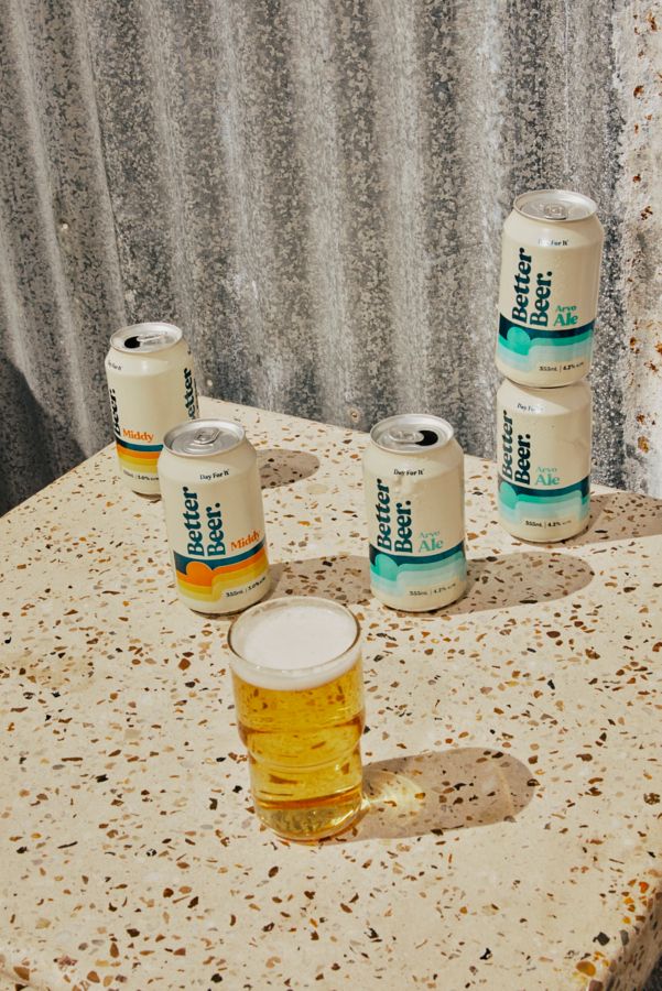 Cans of Better Beer Middy and Arvo Ale on a table with a glass of beer