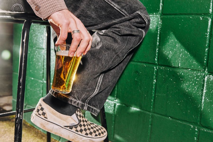 Holding a pot of lager in a bar 