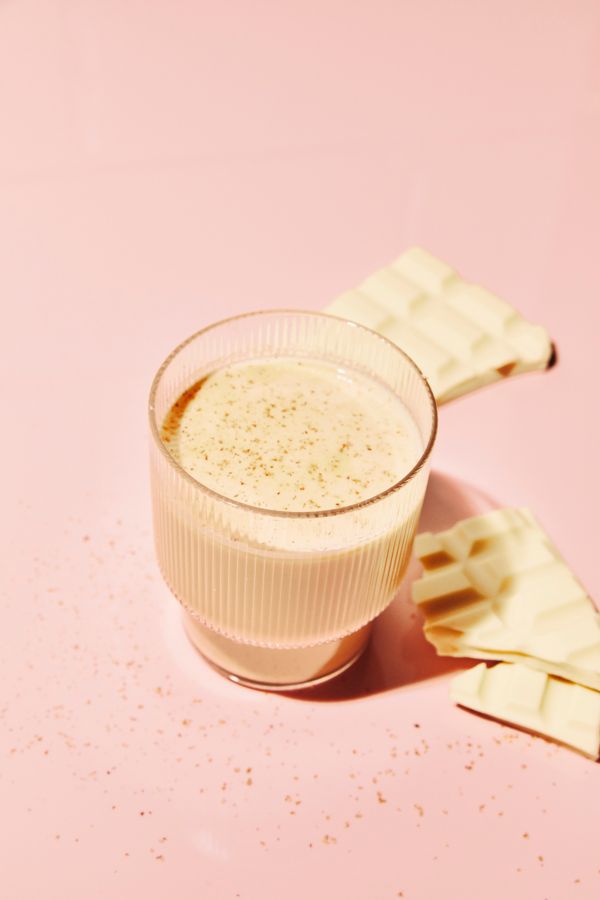 The Baileys White Hot Chocolate cocktail, with a block of white chocolate 