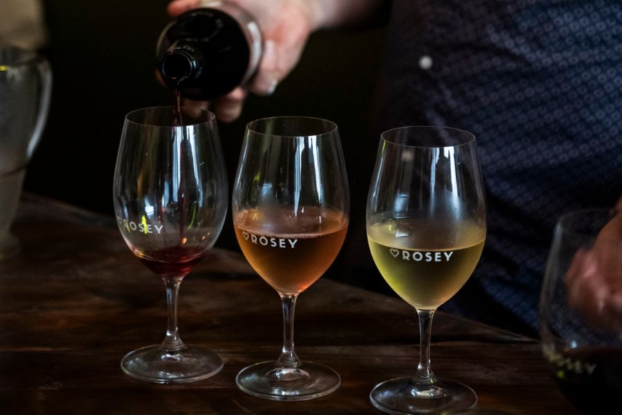 Pouring three glasses of wine at Hey Rosey in Orange