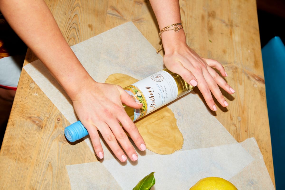 Audrey using wine bottle as rolling pin