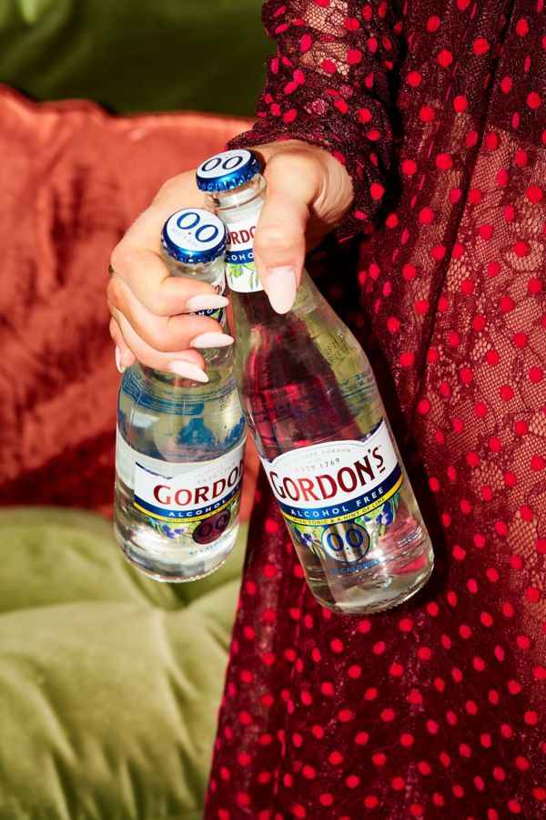 Olivia holding two Gordons gin and tonics