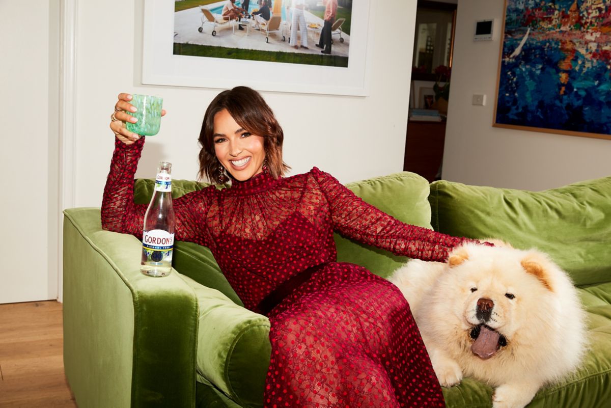 Olivia drinking a Gordons Zero gin and tonic with her dog Ziggy