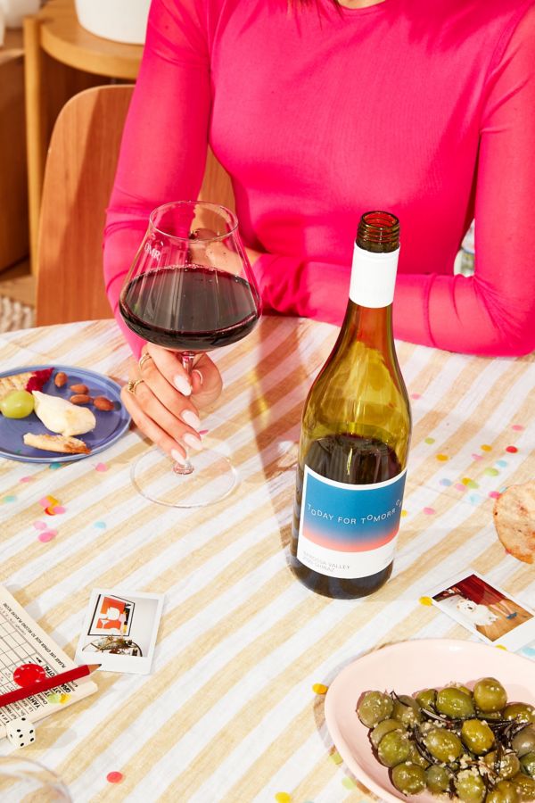 Olivia drinking non alc wine at the dinner table