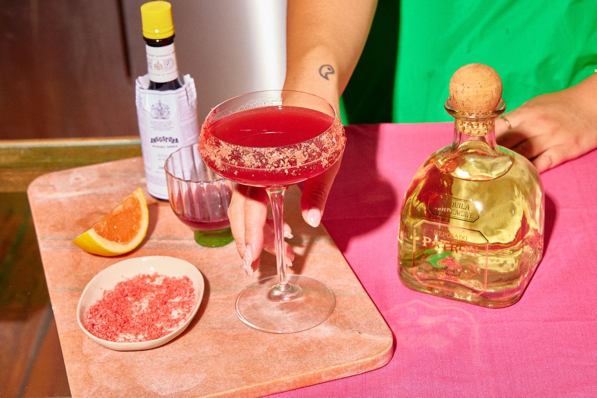 The Pink Paradise cocktail with a bottle of tequila