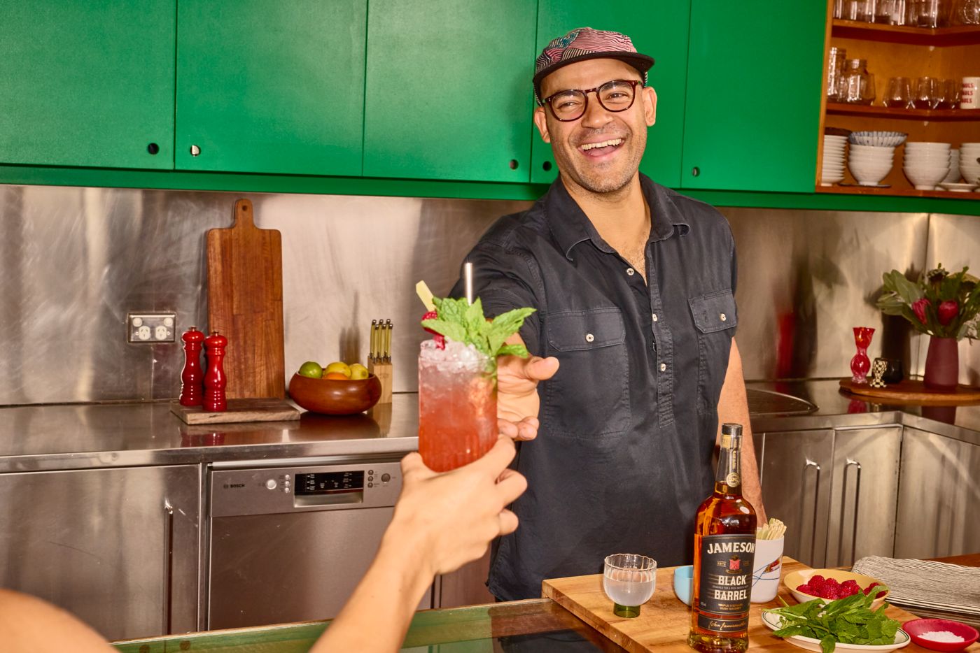 Bartender Matt Stirling reaching for a Young Liars cocktail 